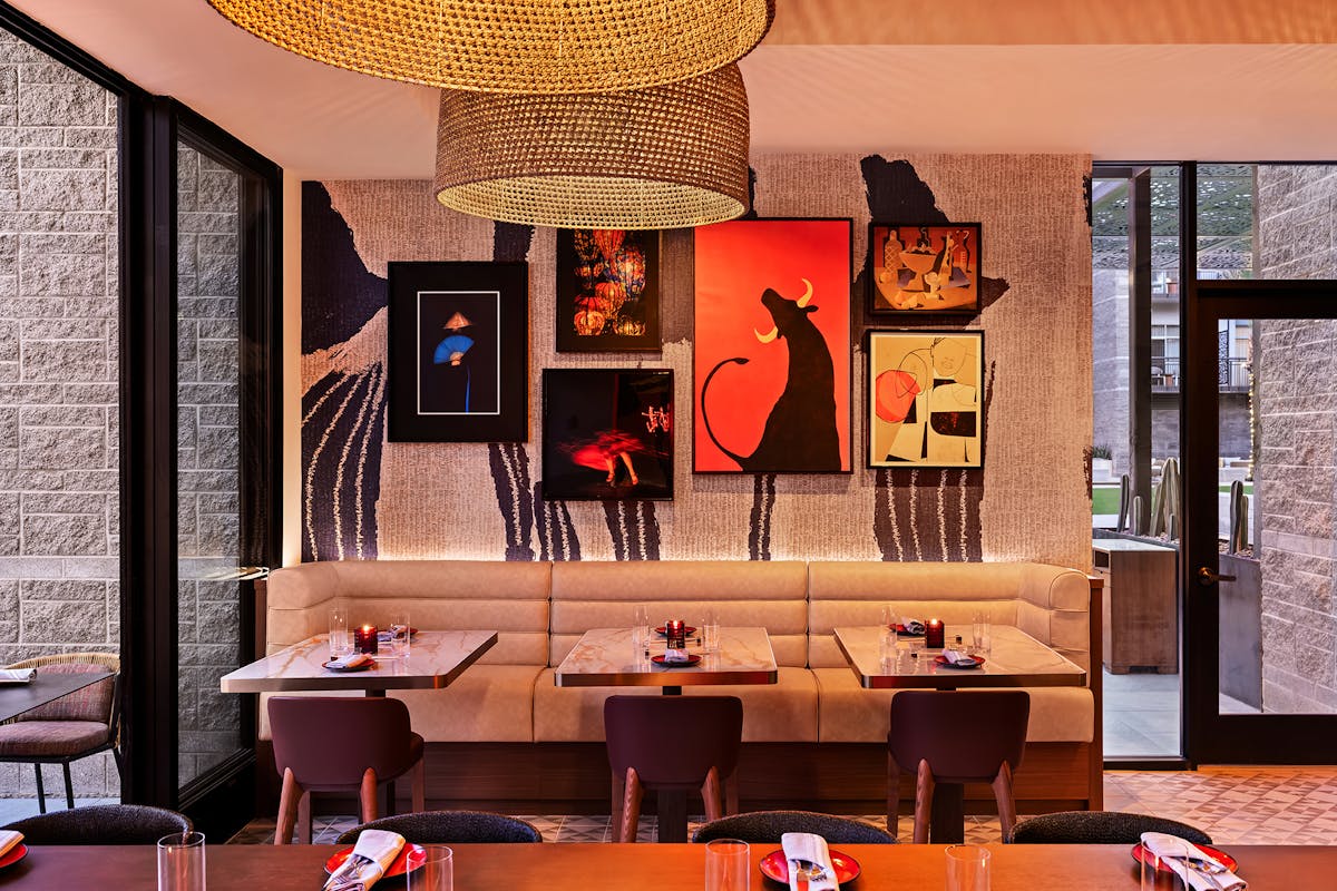 a living room filled with furniture and vase of flowers on a table